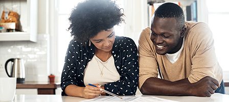 Couple reviewing documents at home