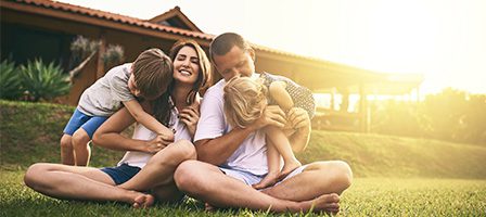 Happy family sitting outdoors