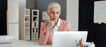 Professional woman in pink blazer, focused