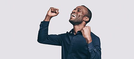 Man celebrating with raised fists