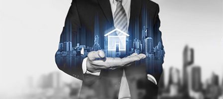 Businessman holding digital cityscape hologram