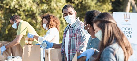 People wearing masks at a food drive