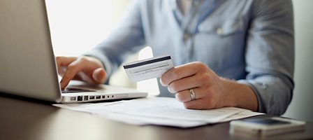 Online payment with card and laptop