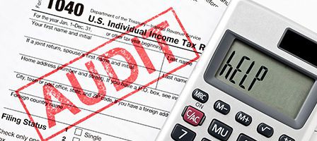 Tax form with "Audit" stamp and calculator