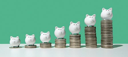 Increasing piggy banks on coin stacks