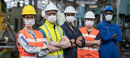 Workers wearing safety gear in factory