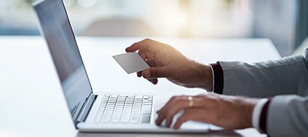 Laptop and card in hand