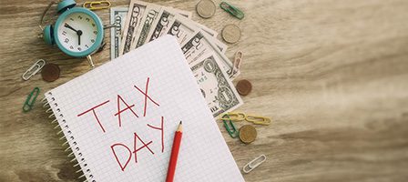 Tax day reminder on a wooden table