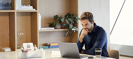Man working on laptop at desk