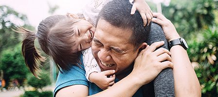 Happy child on dad's shoulders