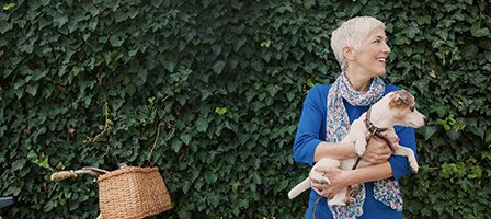 Elderly woman enjoying time with pet dog