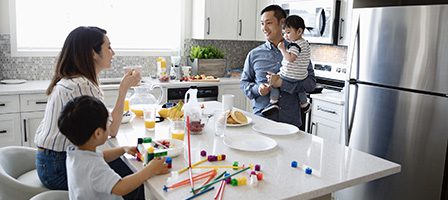 Family enjoying breakfast in modern kitchen