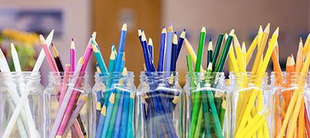Vibrant pencils displayed in jars