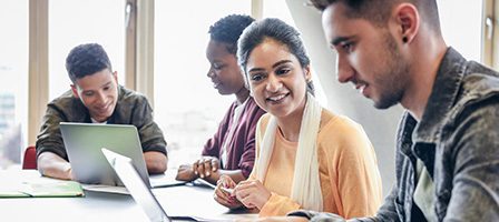 Diverse group studying together in a classroom