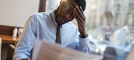 Person in thought while reading document