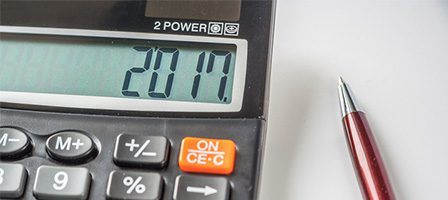 Digital calculator and red pen close-up.