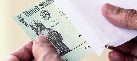 U.S. Treasury check being removed from envelope