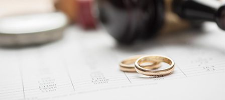 Marriage paperwork with golden rings