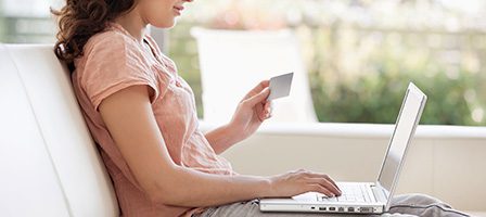 Side view of woman holding credit card