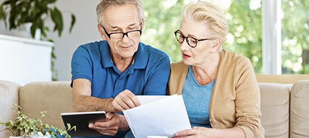 Mature couple discussing finances at home