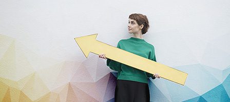 Woman in green sweater with arrow
