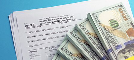 Tax forms and dollar bills