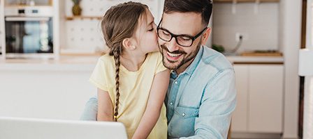 Happy father and daughter in kitchen