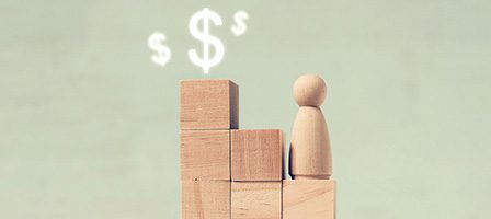 Wooden blocks and dollar symbols