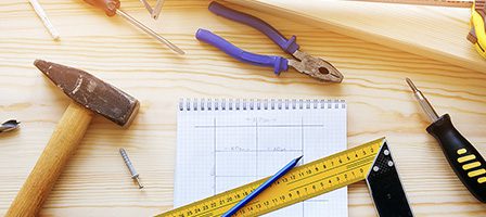 Woodworking tools and notebook on table