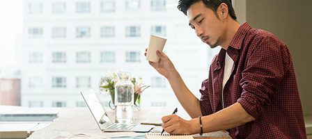 Man working at desk with coffee