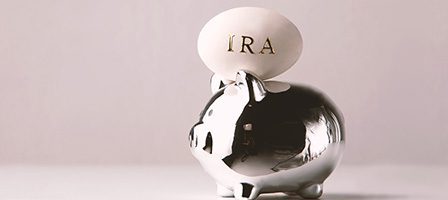 IRA egg atop silver piggy bank