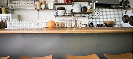 Modern kitchen with wooden stools and shelves