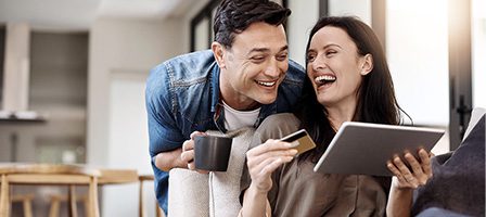 Smiling pair enjoying digital device together