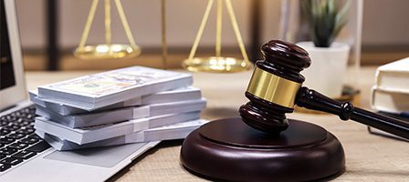 Legal symbols with cash and laptop