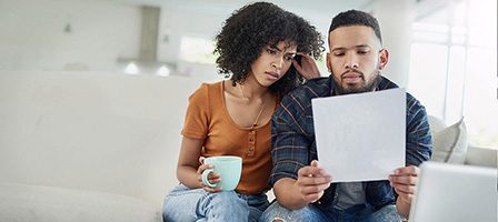 Worried couple looking at paperwork