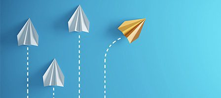 Origami planes on blue background