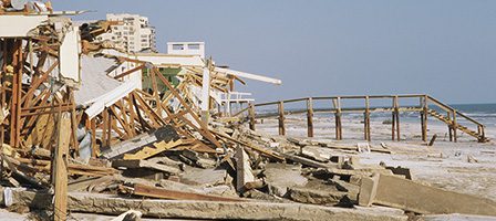 Destroyed beachfront buildings and debris