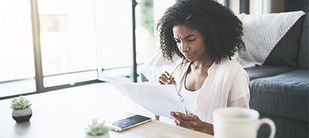 Woman reading documents at home