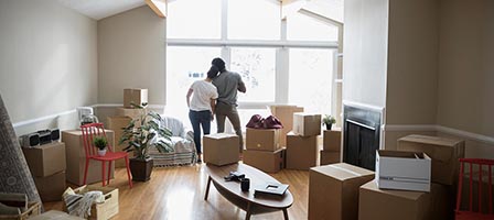 Couple in room with moving boxes