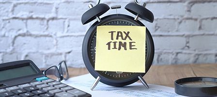 Tax time reminder on sticky note