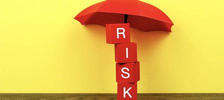 Risk cubes under red umbrella