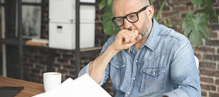 Man reading documents thoughtfully
