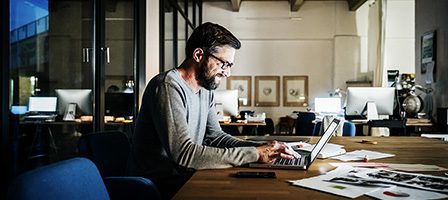 Designer focused on laptop in office