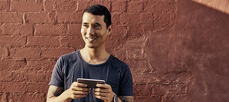 Person smiling while holding a smartphone