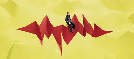 Man on jagged red structure, yellow background