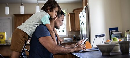 Man multitasking with laptop and tablet