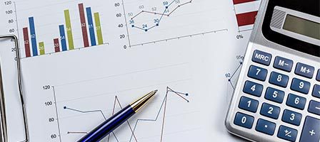 Calculator and graphs on financial documents