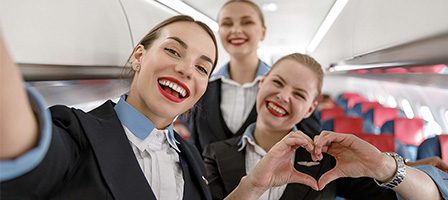 Flight attendants smiling on airplane