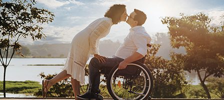 Couple kissing by a lake