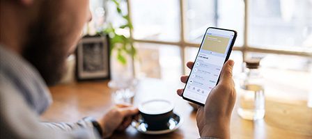 Man using smartphone in cafe